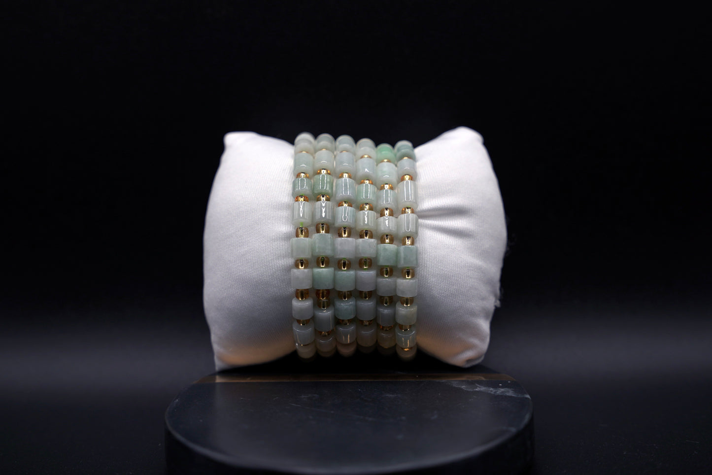 Layered jade bracelet stack styled for luxury and spiritual elegance