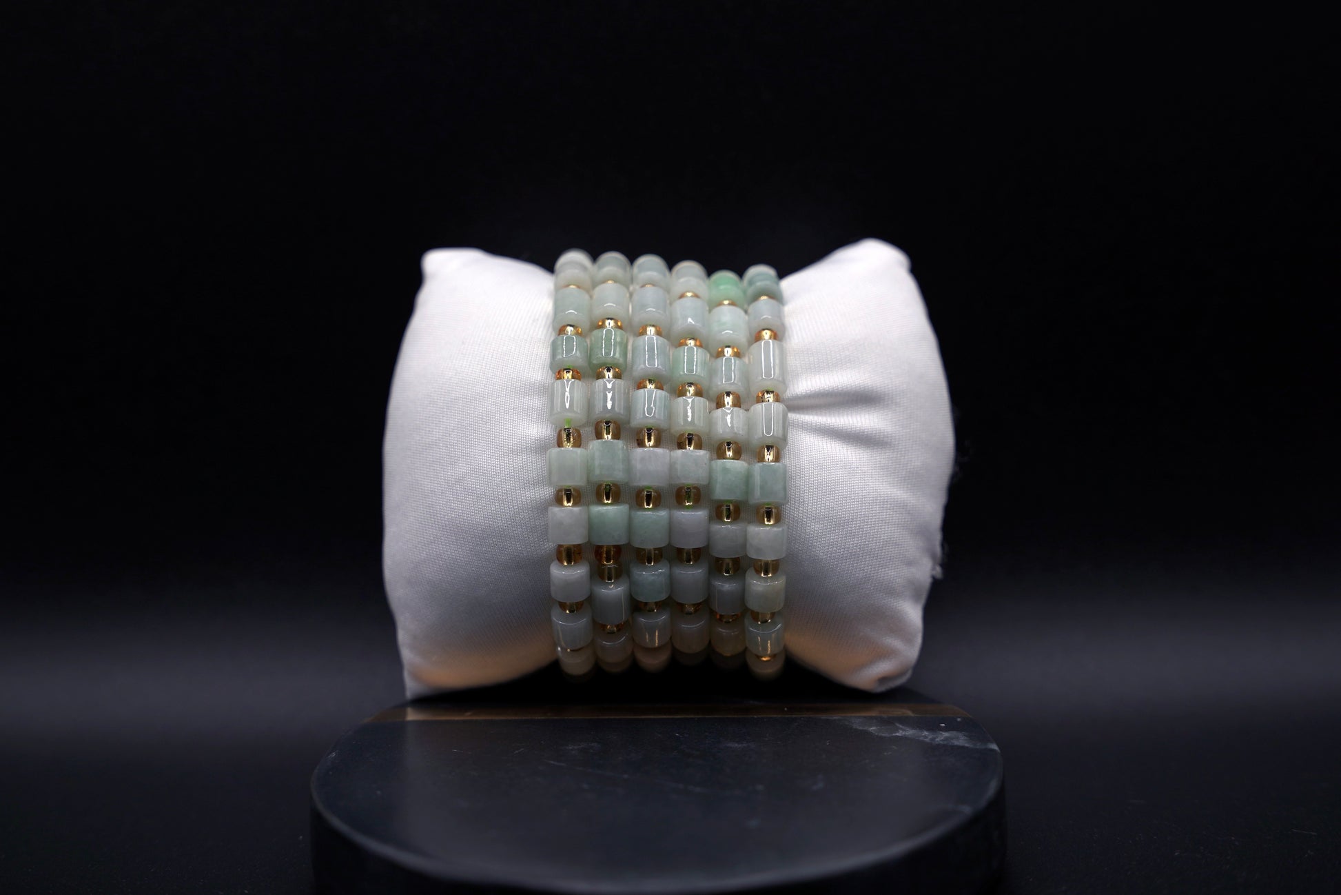 Layered jade bracelet stack styled for luxury and spiritual elegance