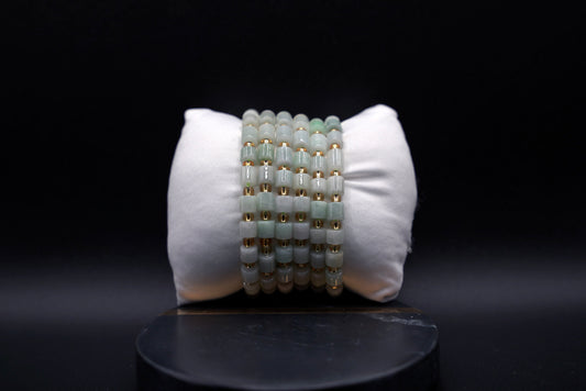 Layered jade bracelet stack styled for luxury and spiritual elegance