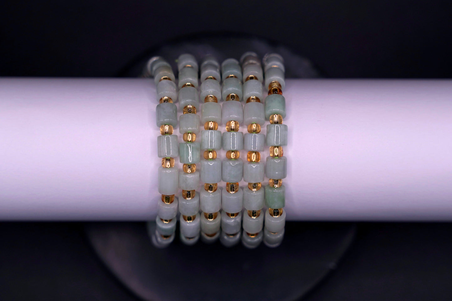 Layered jade bracelet stack styled for luxury and spiritual elegance