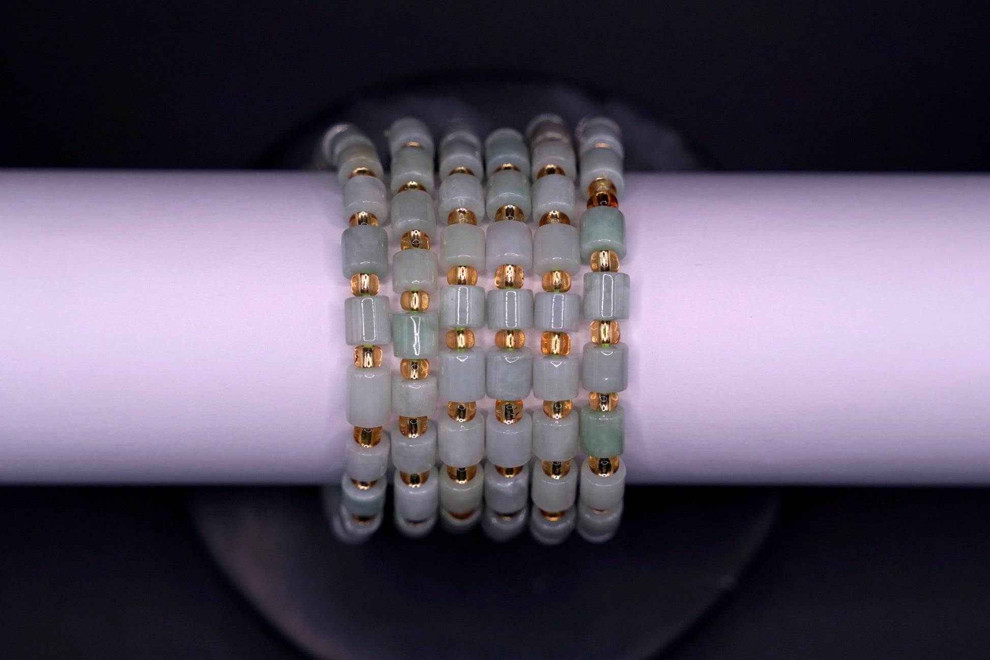 Layered jade bracelet stack styled for luxury and spiritual elegance