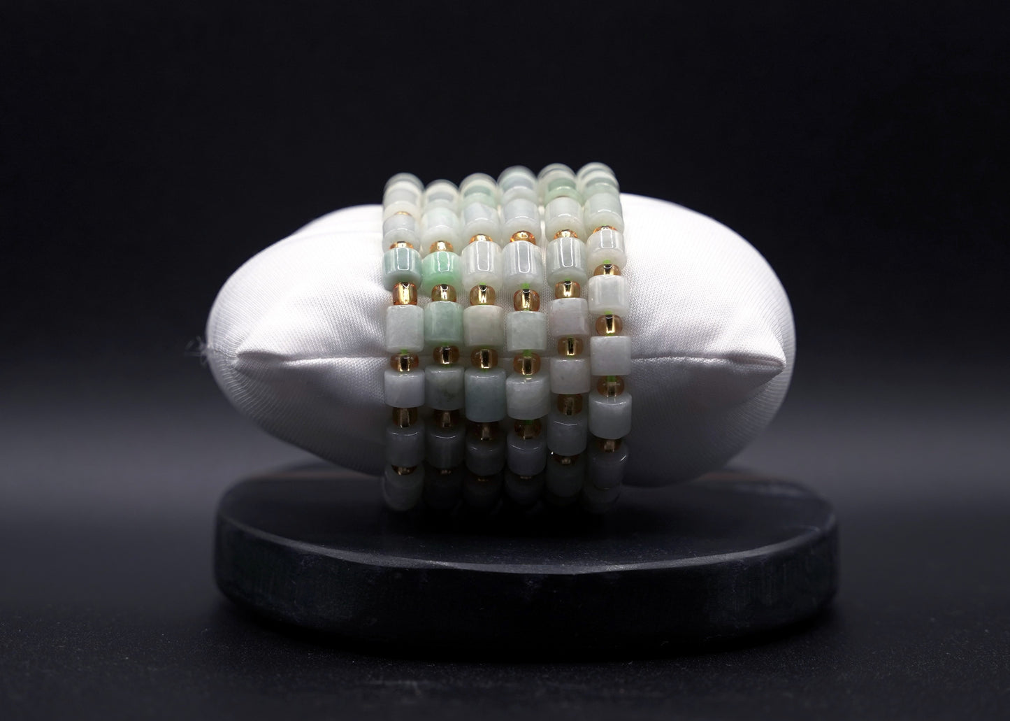 Layered jade bracelet stack styled for luxury and spiritual elegance