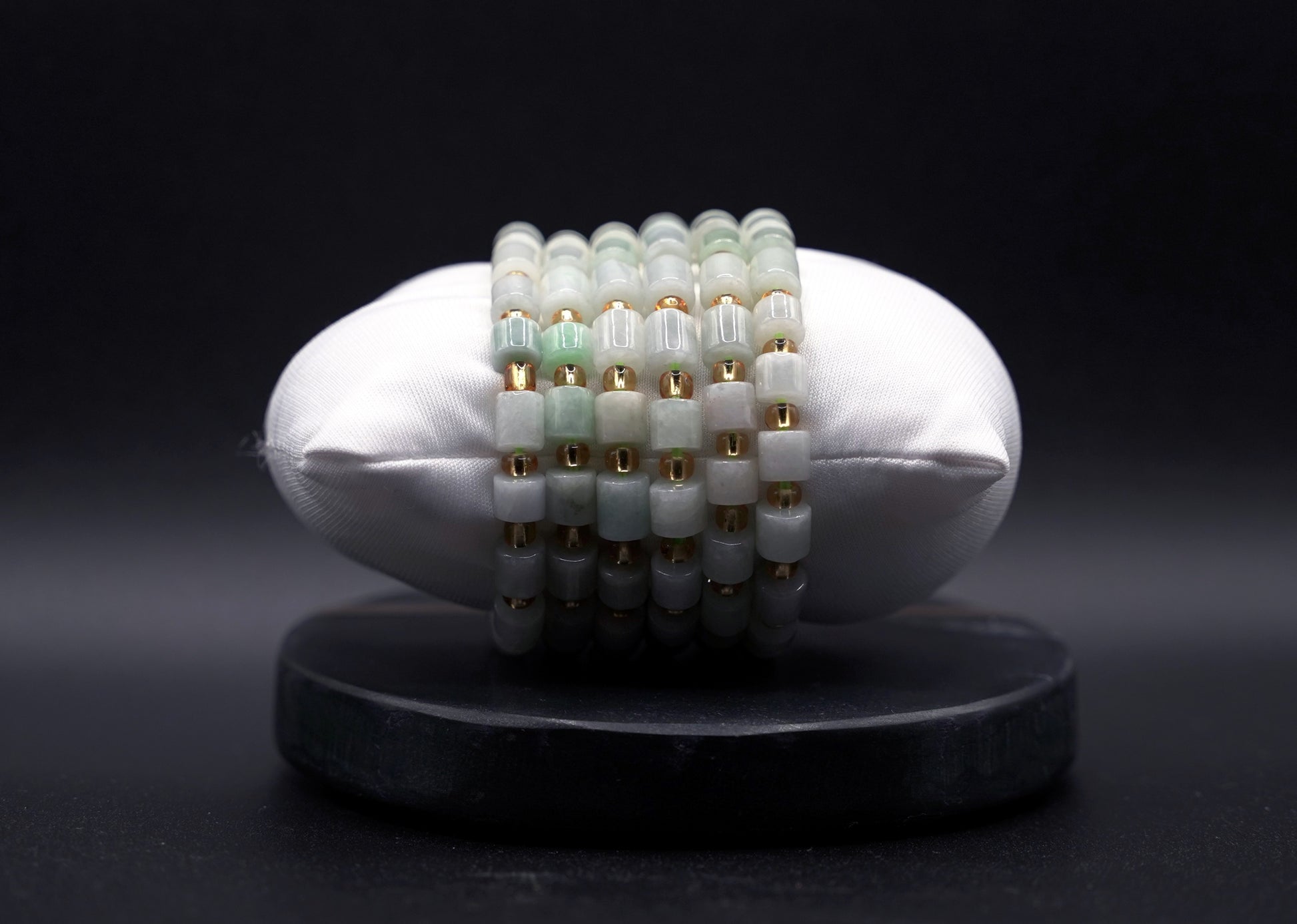 Layered jade bracelet stack styled for luxury and spiritual elegance