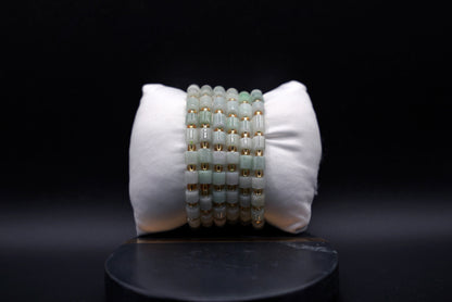 Layered jade bracelet stack styled for luxury and spiritual elegance