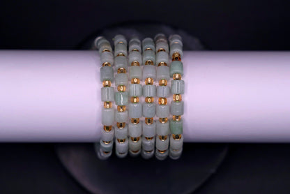 Layered jade bracelet stack styled for luxury and spiritual elegance